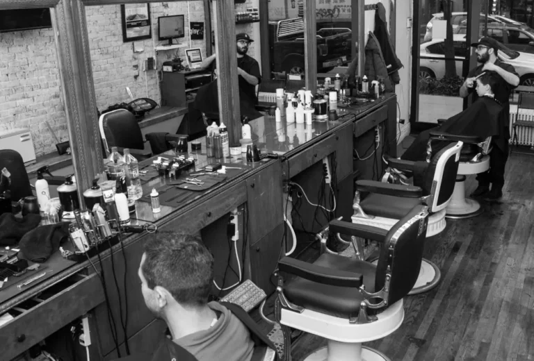 Black-and-white view of the barber chairs and stations