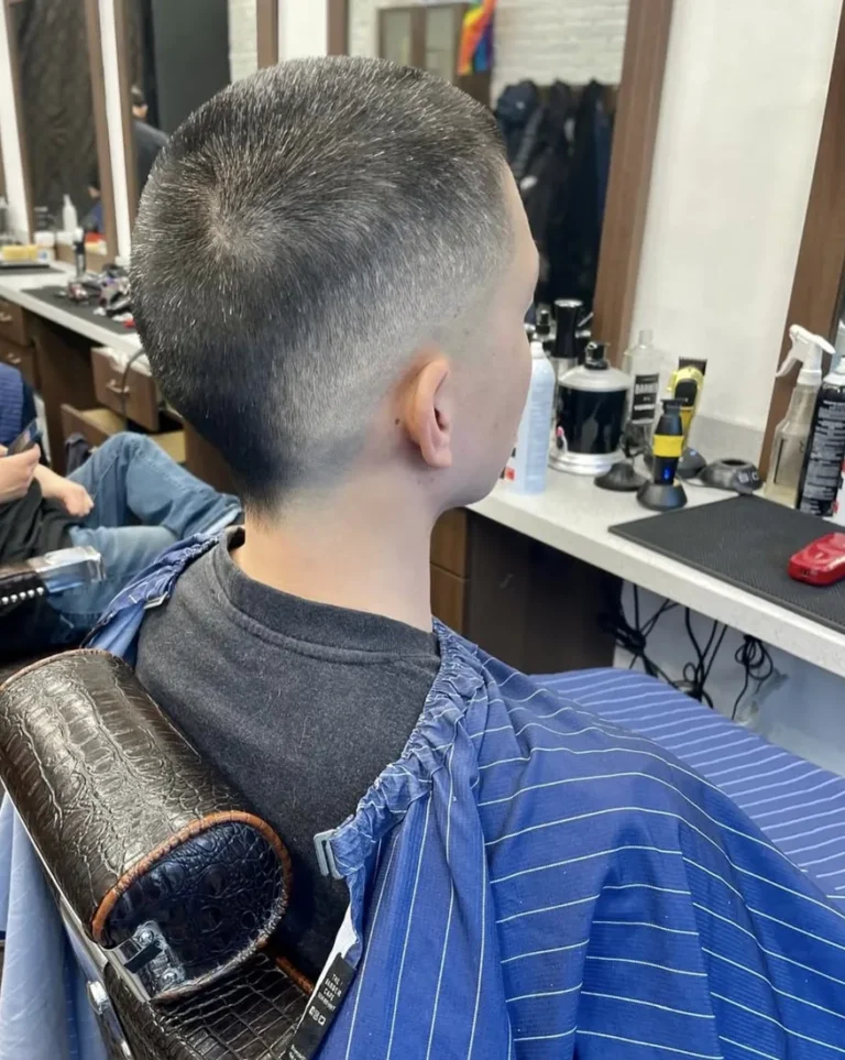 Short buzz cut with a low fade, rear view